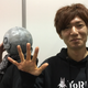 Takahisa Taura poses with Yoko Taro in the background